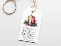 a christmas gift tag with three candles on it and the words, wishing you a scent station