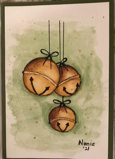 a card with three oranges hanging from strings