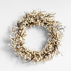 a wreath with white flowers and branches on a white background, ready to be used as an ornament