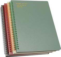 three spiral bound notebooks stacked on top of each other with the words green, red, and yellow