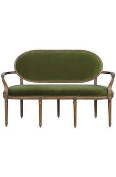 a green couch sitting on top of a wooden frame