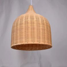 a wicker light fixture hanging from a ceiling