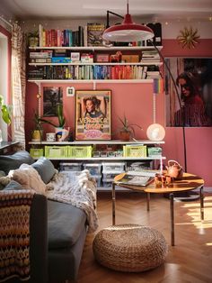 a living room filled with lots of furniture and bookshelves on top of it