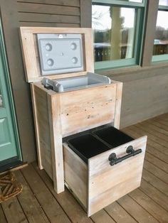 a wooden box sitting on top of a wooden floor next to an open window and door