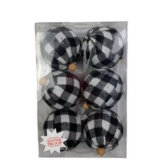 four black and white plaid ornaments in a package