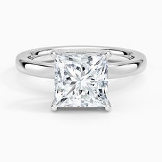 a princess cut diamond engagement ring on a white background with the band around it's edge