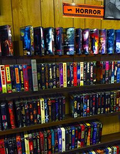 the shelves are full of movies and dvds