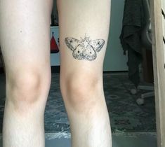 a person with a butterfly tattoo on their leg