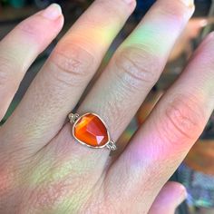 The incredible texture in this striped Rosecut Carnelian is truly one of a kind. Set in 14k yellow gold with accent beads and a freeform sterling silver band. Approximate stone size: 13mm x 10mm 2.85 cts Mohs Stone Hardness: 6 This one of a kind piece is handmade to in Emily's Hudson Valley studio. This piece is in stock and can be resized prior to shipping. If you have questions about sizing, shipping or need help deciding please reach out to us! Orange Carnelian Jewelry For Anniversary, Orange Moonstone Ring As A Gift, Amber Carnelian Gemstone Rings, Carnelian Amber Gemstone Rings, Carnelian Orange Rings For Gifts, Orange Carnelian Rings For Gifts, Classic Carnelian Ring, Classic Carnelian Ring Jewelry, Silver Rings With Polished Carnelian