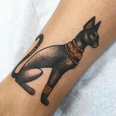 an egyptian cat tattoo on the leg