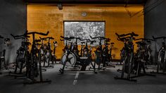 an indoor gym with many bikes and exercise equipment