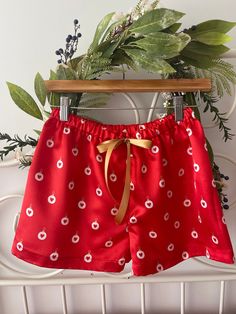 Delicate  and trendy Christmas satin pyjamas shorts made of  quality satin with cute Christmas baubles and little harts on red background.  This can be a beautiful photo prop or lounge wear. Also I can make matching Mother and daughter shorts per request or matching bridesmaids shorts for weddings around festive Season  Featuring an elasticized waist for comfort and easy dressing with a ribbon bow tie accent at front. These pj shorts has no side seams making more comfortable for sleeping.  Each of my items is handmade in small quantities with quality fabrics and attention to detail to ensure a professional finish. All seams are overlock stitched  Sizing:  made to order. Please message me in conversation what size you need or you can send the hips measurements and the desired length. Pyjamas Shorts, Christmas Bridesmaids, Ribbon Bow Tie, Satin Pyjamas, Matching Bridesmaids, Pj Shorts, Satin Shorts, Easy Dressing, Handmade Gift Wrap