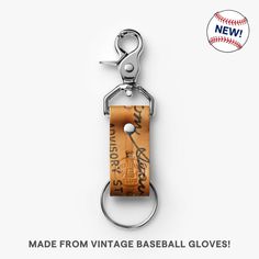 a leather keychain with an image of a baseball and the words made from vintage baseball gloves