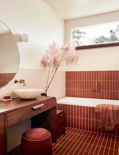 a bath room with a sink a mirror and a bath tub next to a window