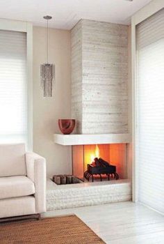 a living room with a fire place in the corner