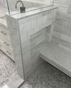 a bathroom with marble counter tops and drawers