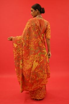 Orange tissue saree with floral hand painting and hand embroidered borders. Comes with an unstitched blouse piece. - Aza Fashions Cotton Silk Pre-draped Saree With Printed Motifs, Traditional Drape Cotton Silk Sets With Floral Print, Fitted Floral Print Cotton Silk Dupatta, Anarkali Style Pre-draped Saree With Printed Motifs, Cotton Silk Dupatta With Floral Print For Diwali, Unstitched Suit In Cotton Silk With Printed Motifs, Traditional Floral Print Pre-draped Saree For Eid, Wedding Pre-draped Cotton Silk Saree With Printed Motifs, Anarkali Semi-stitched Pre-draped Saree With Printed Motifs