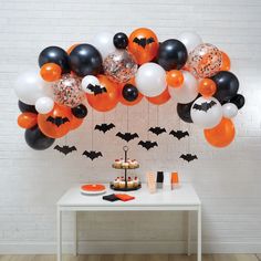 a table topped with balloons and halloween decorations