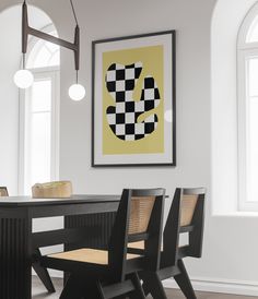 a black table with four chairs and a yellow checkerboard print on the wall