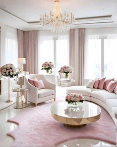 a living room filled with white furniture and pink flowers on top of a coffee table