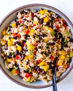 a bowl filled with rice and beans on top of a table