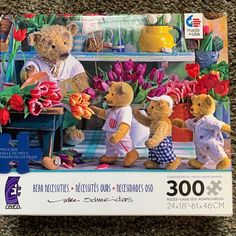 a puzzle box with three teddy bears in front of tulips and other flowers