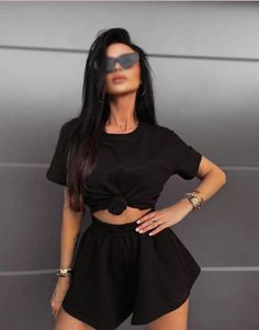 Unveil your style with this sophisticated black outfit. Featuring a chic knotted crop top and ultra-comfortable high-waisted shorts, this ensemble effortlessly combines fashion and comfort. Ideal for every casual outing or laid-back gathering, this versatile set will elevate your wardrobe. Available in various sizes to fit every body type, this must-have outfit ensures you step out in confidence and charm. Black Two-piece Crop Top For Summer, Summer Black Two-piece Crop Top, Black Two-piece Set For Summer, Black Summer Two-piece Tops, Short Sleeve Two-piece Crop Top, Casual Black Short Set For Summer, Chic Black Two-piece Crop Top, Black Cropped Sets For Summer, Black Cropped Summer Sets