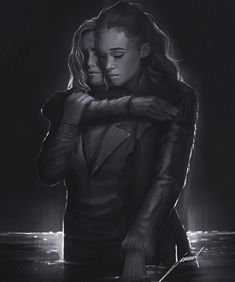 two people embracing in the dark with their arms around each other, and one person holding another