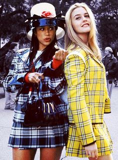 two young women dressed in plaid outfits posing for the camera