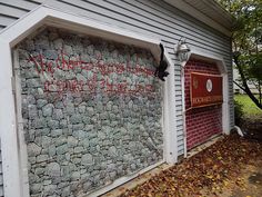 a sign on the side of a building that has been vandalized with graffiti