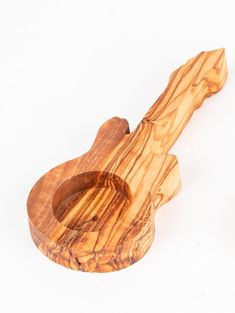 a wooden guitar shaped object on a white background