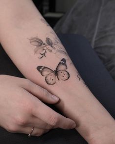 a woman with a butterfly tattoo on her arm