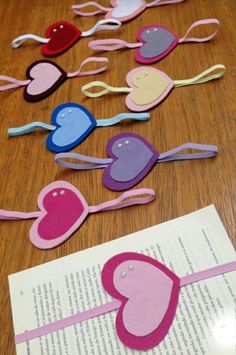 paper hearts are laid out on top of an open book