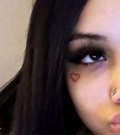 a close up of a person with heart on her nose