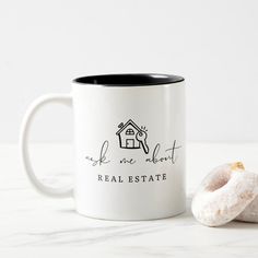 a couple of doughnuts sitting on top of a table next to a coffee mug