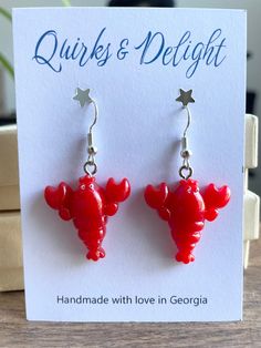 Hey ocean lovers! Add a touch of coastal charm to your look with these playful lobster earrings. Handmade with love using hypoallergenic hardware, these vibrant red resin earrings feature adorable lobster-shaped charms for a fun, whimsical accent. They're perfect for adding a quirky flair to your everyday outfit or a themed summer party. Plus, they are nickel-free and lightweight, making them ideal for those with sensitive ears. Whether you're a seafood lover or just enjoy unique accessories, th Lobster Earrings, Coastal Jewelry, Tiny Charm, Red Lobster, Unique Accessories, Fun Cute, Resin Earrings, Ocean Inspiration, Cute Gift