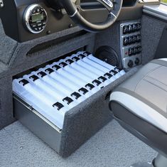 the inside of a boat with drawers and steering wheel on it's center console