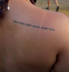 a woman with a tattoo on her back saying wild spirit, don't heart, sweet soul