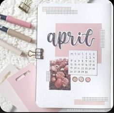 an open planner with the word april written in cursive writing on it, surrounded by other items