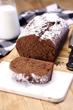 a loaf of chocolate banana bread sitting on top of a cutting board