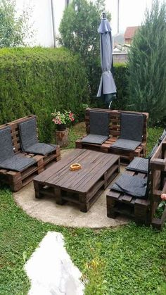 an outdoor seating area made out of wooden pallets