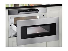 a stainless steel microwave oven with the door open