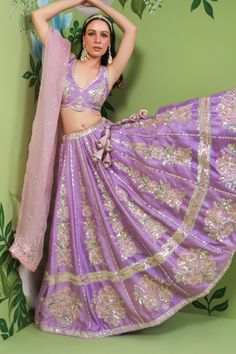 Peri peri purple raw silk lehenga with attached cancan and panels embroidered in sequins, zardozi and applique floral embroidery. Comes with embellished padded blouse and pink organza dupatta.
Component: 3
Pattern: Embroidery
Type Of Work: Sequins, Zardozi, Applique
Neckline: V Neck
Sleeve Type: Sleeveless
Fabric: Lehenga and Blouse: Raw Silk, Dupatta: Organza
Color: Purple
Other Details: 
Attached lining
Sequins, zardozi and applique work
Occasion: Destination Wedding - Aza Fashions Purple Sequined Dress For Diwali, Purple Sequin Sharara For Diwali, Purple Gota Work Dresses For Navratri, Bollywood Style Purple Sharara With Sequins, Purple Sequin Sharara For Reception, Traditional Purple Sequined Sets, Festive Purple Sequined Sets, Festive Purple Sequin Sets, Purple Dola Silk Sets For Reception