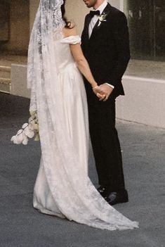 a bride and groom standing next to each other