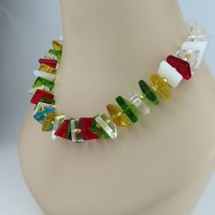 This unique necklace with its translucent abstract shapes is a celebration of light and color!  The geometric shapes include polygons, triangles, squares, and trapezoids.  The riot of colors include red, green, honey, turquoise, and white with a few clear in the mix.  The glass shapes resemble the pieces used to create a stained glass mosaic, but all the sides, edges, and corners are smooth.  Though the components appear complex, the necklace design is simple, allowing the glass shapes to speak Modern Multicolor Geometric Jewelry, Modern Multicolor Rectangular Jewelry, Unique Multicolor Geometric Jewelry, Multicolor Necklaces For Jewelry Making In Various Shapes, Unique Multicolor Rectangular Necklace, Modern Multicolor Jewelry With Unique Variations, Unique Multicolor Necklace, Modern Multicolor Glass Jewelry, Amazing Necklaces