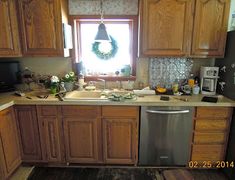 a kitchen with wooden cabinets and a silver dishwasher