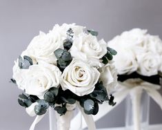 the bridal bouquets are white roses and green leaves