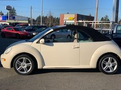 a small white car parked in a parking lot