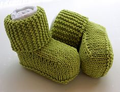 a pair of green knitted baby boots