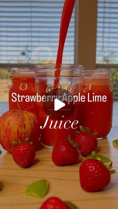 strawberries and apples sit in jars with the words, strawberry apple line juice on them